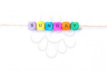 sunday word of multicolored cubes on a white background