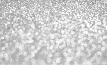 Silver bokeh holiday textured glitter background.defocused abstract Silver christmas background