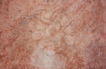 Ancient wall, the surface of the Orange, natural, pink marble in the cracks