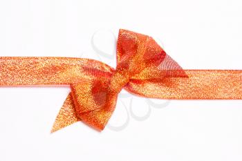 Red golden, orange  ribbons with bow with tails  on white background. The concept of gift, holiday