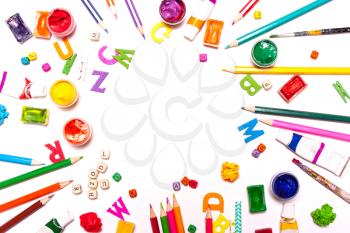 A background of colored pencils, paints. Workplace designer, artist, concept art
