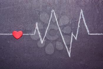 The cardiogram of the heart is painted with chalk on a blackboard. Concept of Love, Valentine's Day