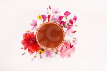 cup of coffee, cocoa in coral pink colors. Pastel floral background. Top view, flat