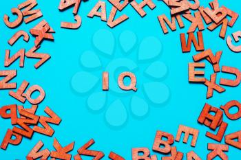 Word ,abbreviation IQ of wooden letters on a blue background
