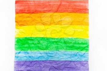 LGBT flag on white crumpled paper.