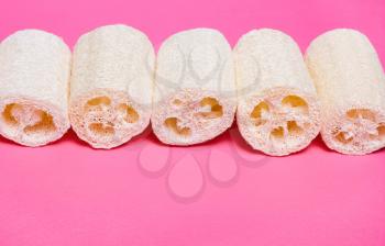 Loofah on a pink background. Organic natural sponge. Zero waste, environmental protection