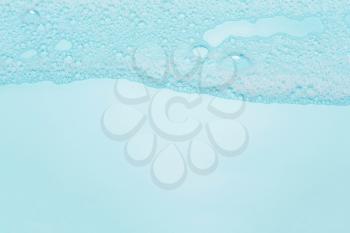 detergent foam, shampoo, soap bubbles on blue background. The concept of cleanliness, cleaning