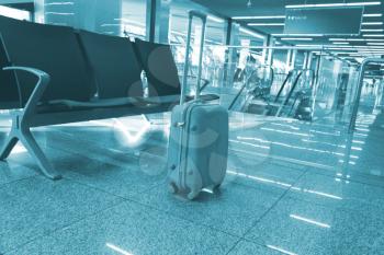 suitcase in the waiting room, at the airport, at the station. Concept travel.blue toning
