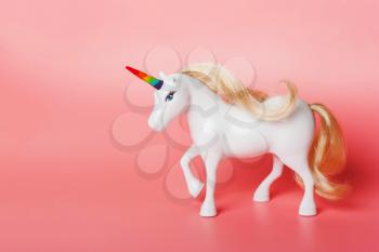 Unicorn with a horn of rainbow colors, LGBT flag on a pink background