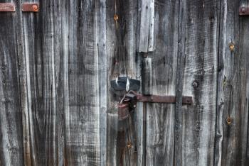 Old, vintage, closed, rural grunge wooden doors with a lock