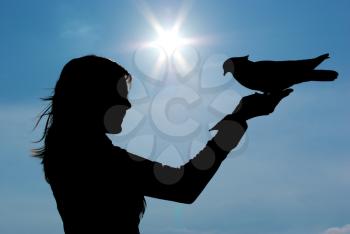 Silhouettes of girl and pigeon. Conceptual design.