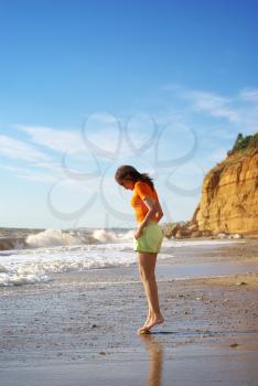 Beautiful girl walking on beach. 