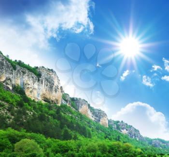Mountain and sun in sky. Nature design.
