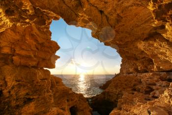 Sunset into grotto. Nature composition. 