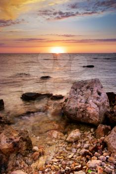 Beautiful seascape. Sea and rock at the sunset. Nature composition.