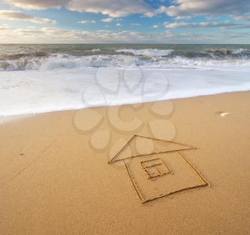 Sea and home on the sea sand. Nature and conceptual composition.
