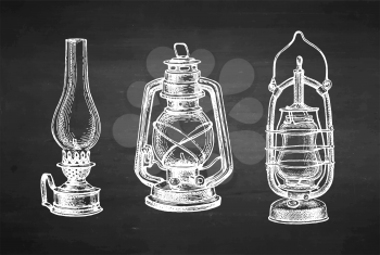 Kerosene lamps. Vintage oil lantern. Chalk sketch on blackboard background. Hand drawn vector illustration. Retro style.