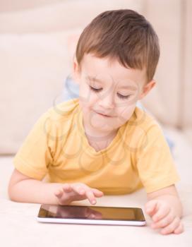 Happy little boy using tablet