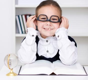 Cute girl is reading book - school, education concept