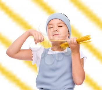 Pretty girl preparing spaghetti, over color background