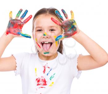Cute girl showing her hands painted in bright colors, isolated over white