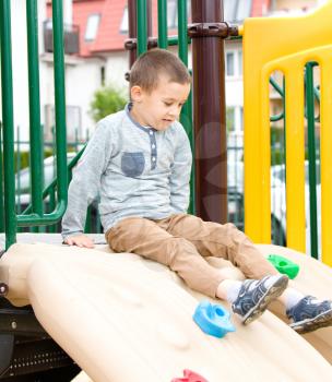 Cute little boy is playing on playground