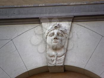 details of architecture, historical buildings of Italy. Stone walls and stone mask.