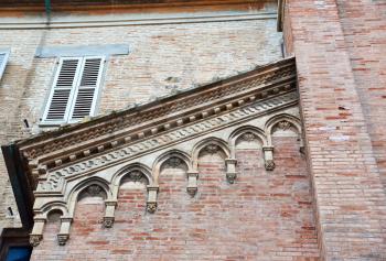 Details architecture of city Senigallia. Cathedral of red stone with fishnet Windows and cone roof. architecture details