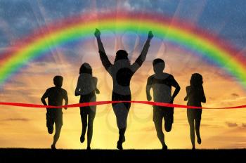 Runners, rainbow, sport. Winning runner crosses the red tape on the background of the rainbow