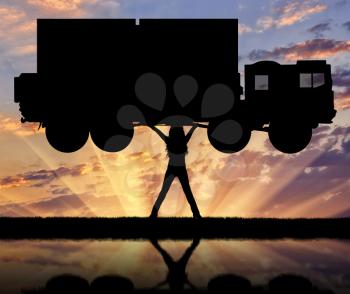Silhouette of strong feminist, lifting trucks and reflection in the water. Concept of feminism.