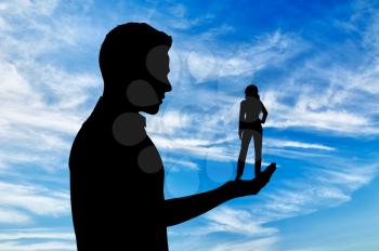 Feminism concept. Silhouette of a man holding a small woman.