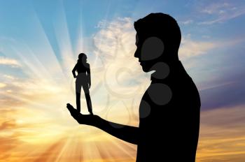 Feminism concept. Silhouette of a man holding a small woman.