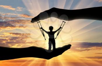 Disabled child standing with crutches in hand sunset. Concept children with disabilities