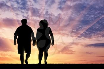 Couple with overweight on sunset background. Overweight concept