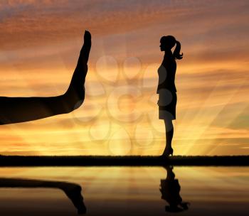 Discrimination and racism concept. Silhouettes of hands stop woman on the sunset background