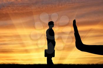 Discrimination and racism concept. Silhouettes of hands stops a man on the sunset background