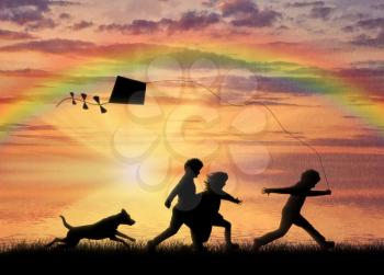 Young children playing sunset with dog and kite flying. friendship concept
