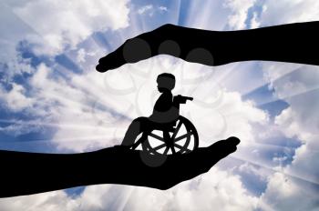 Disabled child in a wheelchair in the hands of man. Concept of care and custody