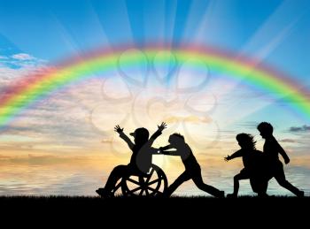 Happy boy in wheelchair playing with children rainbow. Concept happy child disabled