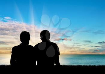 Concept of gay people. Silhouette of two gay men resting on a background of blue sea and sky