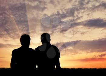 Concept of gay people. Silhouette of two gay vacationers at sunset