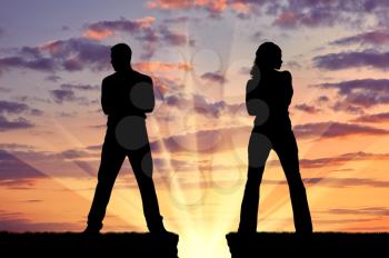 Concept of betrayal and treason. Silhouette of man and woman in a quarrel at sunset