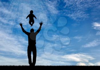 Concept of family values. Silhouettes of happy father and child on the background of blue sky