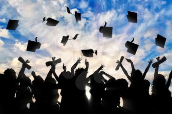 Students graduate cap throwing in sky. Study concept