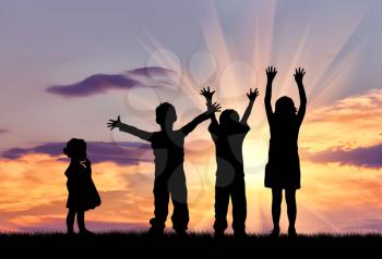 Concept of happiness. Silhouette of happy children on a sunset background