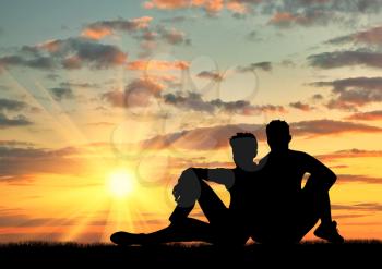 ?oncept of gay people. Silhouette of a pair of gay outdoors at sunset