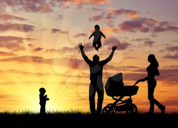 Silhouette of a happy family with children on the background of a sunset