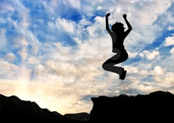 Concept of business success. Silhouette of a happy business woman jumping on top