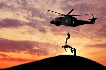 Concept of the evacuation. Silhouette helicopter evacuated the wounded man