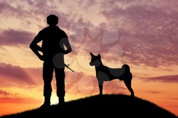 Silhouette of soldiers with weapons and dogs on the top at sunset